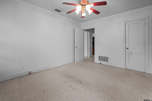 empty room with visible vents, ceiling fan, light carpet, and baseboards