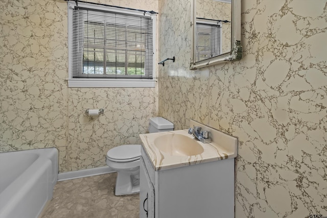 bathroom featuring wallpapered walls, baseboards, toilet, a bathtub, and vanity