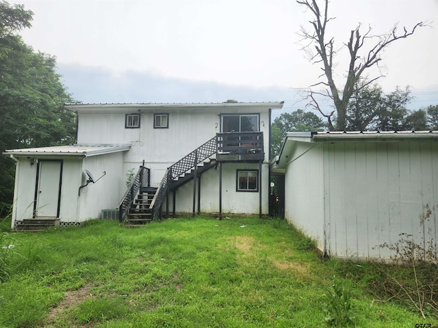 rear view of property with a lawn