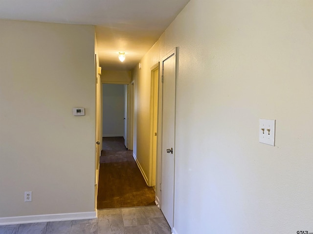 hall with wood-type flooring