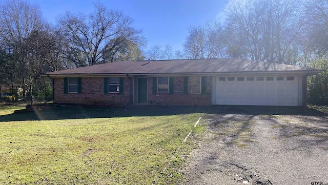 ranch-style house with a garage and a front lawn