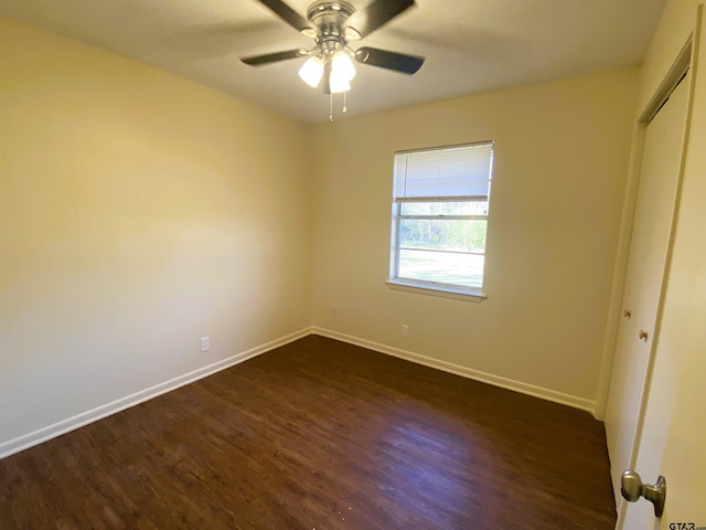 unfurnished bedroom featuring ceiling fan, dark hardwood / wood-style floors, and a closet