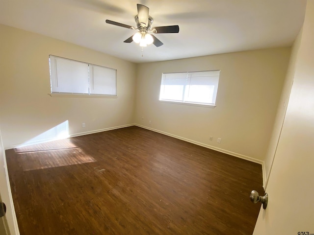 unfurnished room featuring dark hardwood / wood-style floors and ceiling fan