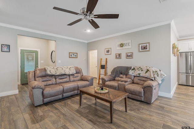 living area with crown molding, baseboards, and wood finished floors