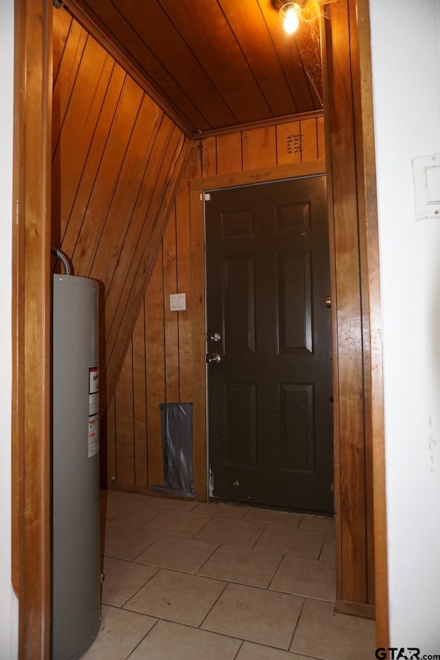 6385 Wagon Tree Trl, Athens, TX 75751 - interior space with light tile patterned floors, wooden ceiling, electric water heater, and wooden walls