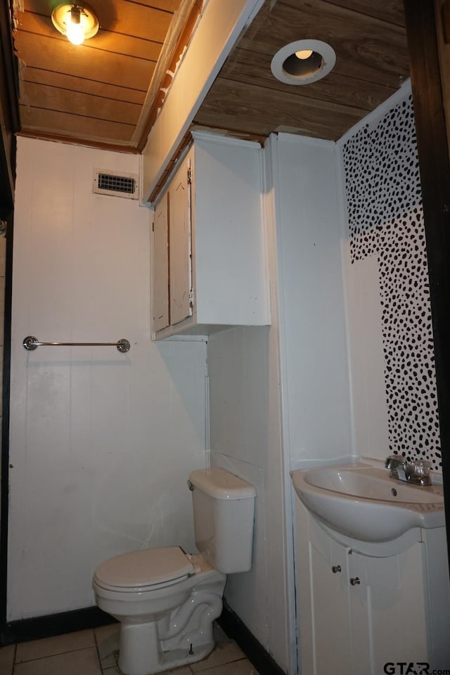 6385 Wagon Tree Trl, Athens, TX 75751 - half bathroom with visible vents, toilet, vanity, tile patterned flooring, and wood ceiling