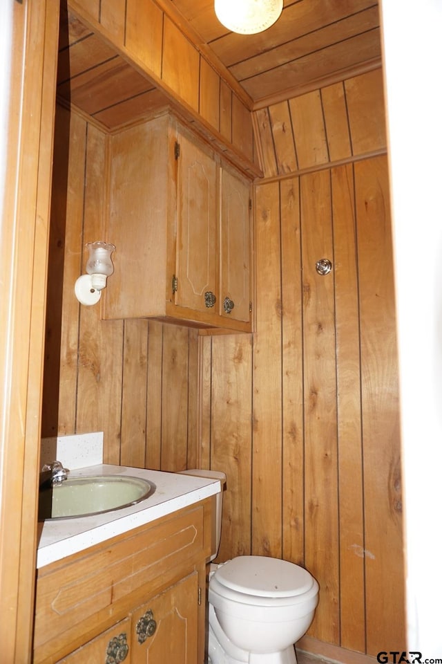 6385 Wagon Tree Trl, Athens, TX 75751 - bathroom featuring toilet, wood ceiling, wood walls, and vanity