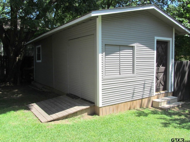 view of outdoor structure featuring a lawn