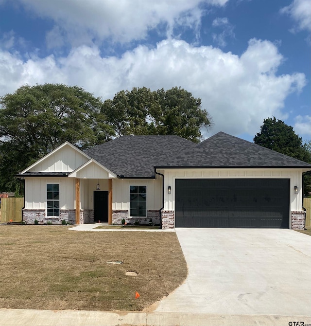 view of front facade with a garage and a front lawn