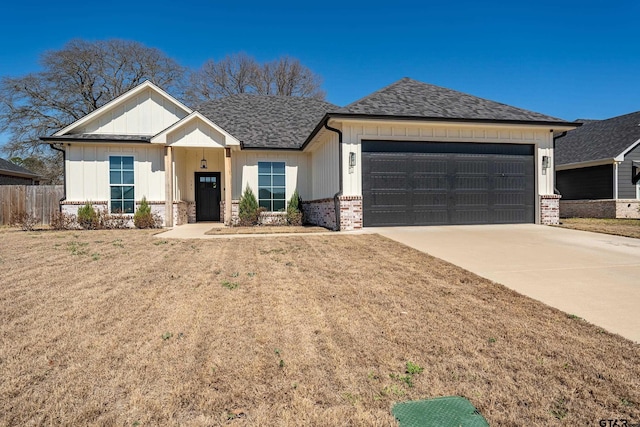 view of front of property featuring a shingled roof, concrete driveway, an attached garage, board and batten siding, and brick siding