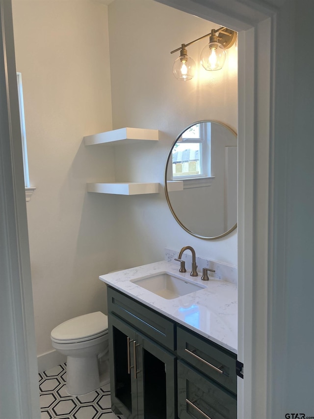 bathroom featuring vanity and toilet