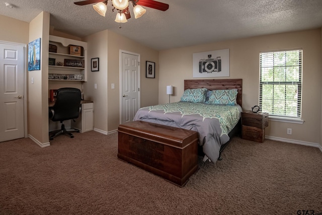 bedroom featuring carpet, ceiling fan, and a textured ceiling