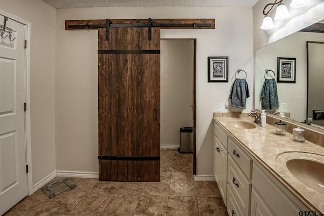 bathroom featuring tile patterned floors, vanity, and a textured ceiling