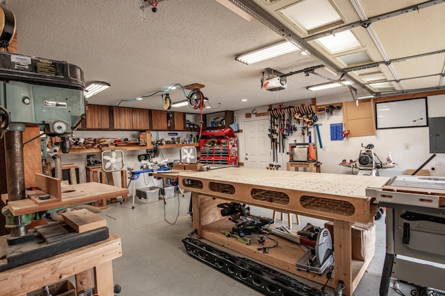 miscellaneous room with a workshop area, electric panel, and a textured ceiling