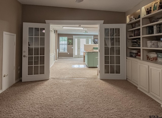 interior space with light carpet and french doors