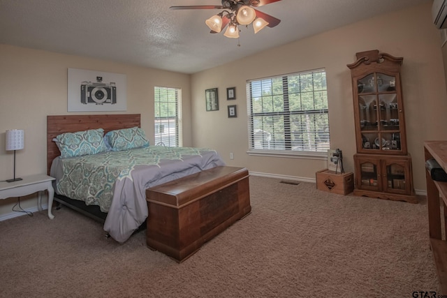 carpeted bedroom featuring a wall mounted air conditioner, a textured ceiling, multiple windows, and ceiling fan