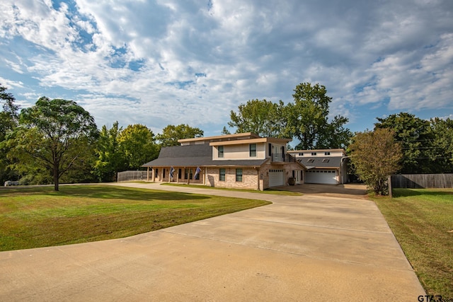 view of front of property featuring a garage and a front yard