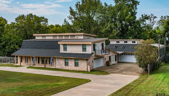 view of front of home with a garage and a front lawn