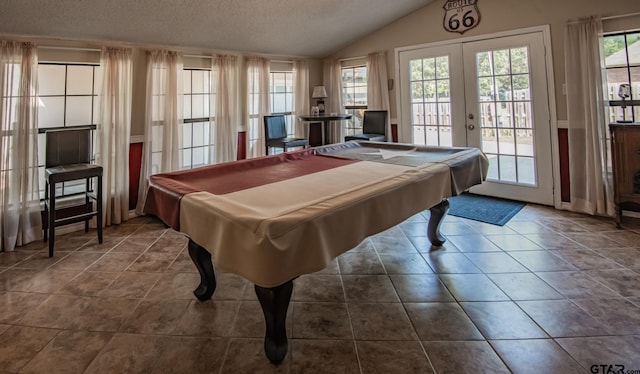 game room with a textured ceiling, french doors, a healthy amount of sunlight, and lofted ceiling