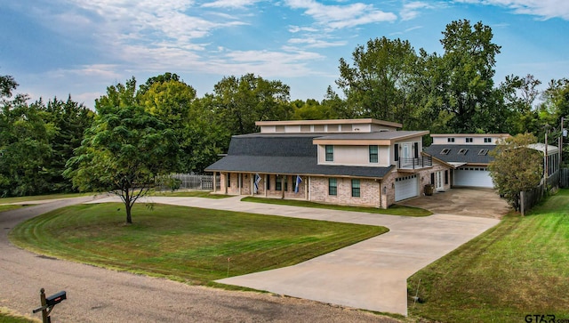 view of front of house featuring a garage and a front lawn