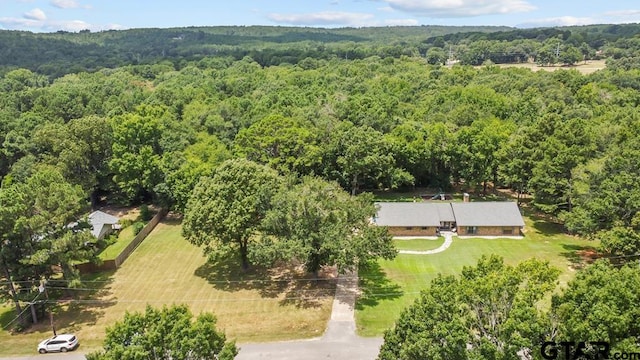 drone / aerial view featuring a view of trees