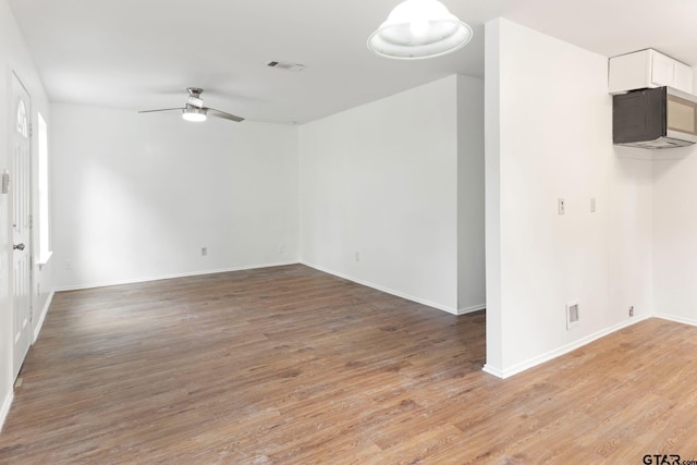 unfurnished room featuring ceiling fan and wood-type flooring