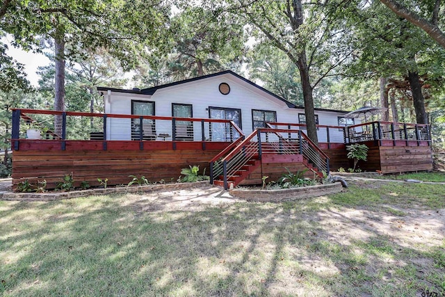 306 Lake Dr, Mount Vernon, TX 75457 - view of front of house with a deck, stairway, and a front lawn