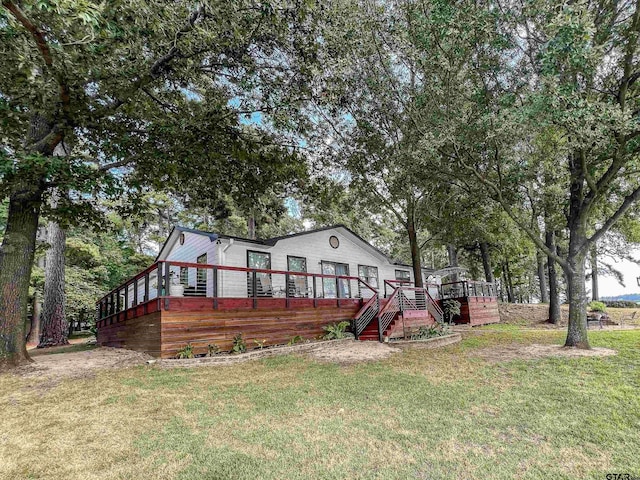 306 Lake Dr, Mount Vernon, TX 75457 - view of front of home featuring a wooden deck, a front yard, and stairs
