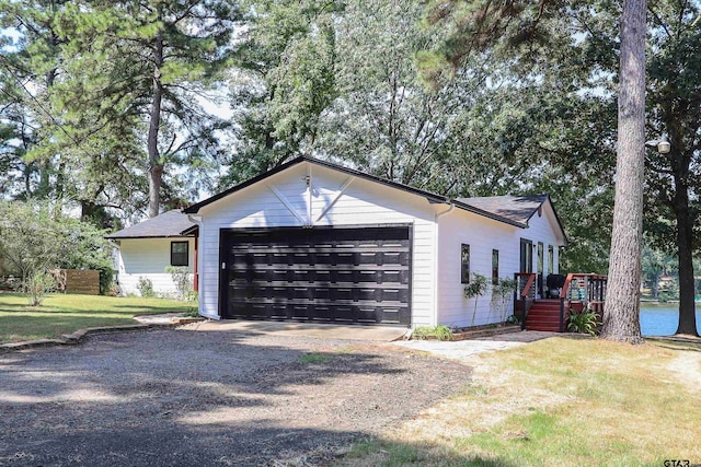 306 Lake Dr, Mount Vernon, TX 75457 - view of home's exterior featuring a garage, driveway, a yard, and a wooden deck