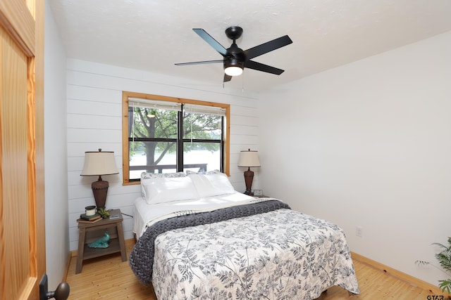 306 Lake Dr, Mount Vernon, TX 75457 - bedroom featuring light wood-style floors, baseboards, and ceiling fan