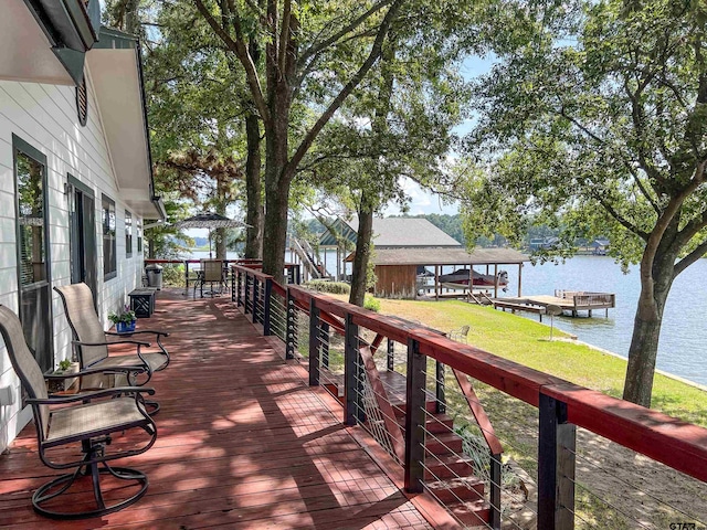 306 Lake Dr, Mount Vernon, TX 75457 - wooden deck with a water view, a boat dock, and a lawn