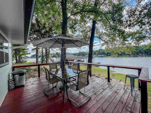 306 Lake Dr, Mount Vernon, TX 75457 - wooden terrace featuring a water view, outdoor dining space, and a yard