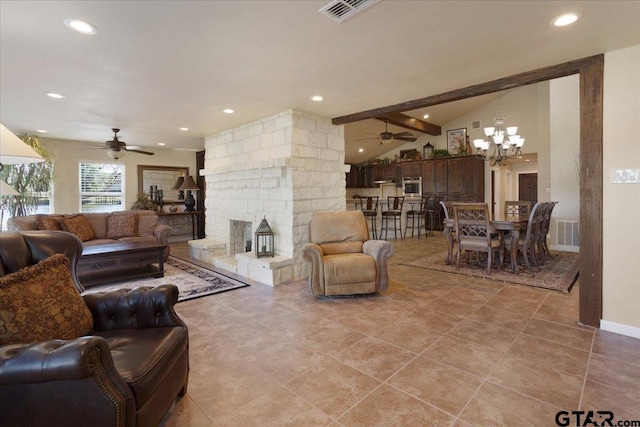 living room featuring ceiling fan with notable chandelier, lofted ceiling with beams, light tile patterned floors, and a stone fireplace