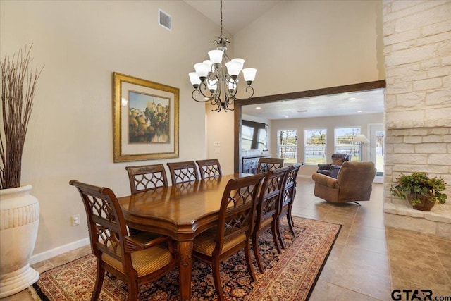 dining room with a chandelier and high vaulted ceiling