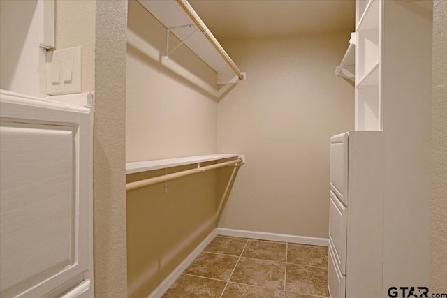 walk in closet featuring tile patterned flooring