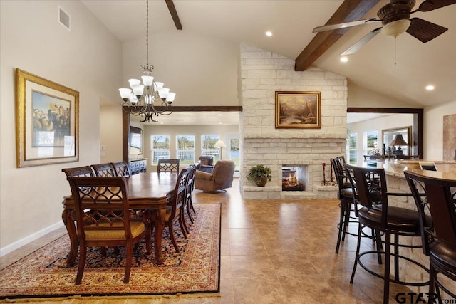 dining space featuring a fireplace, beamed ceiling, ceiling fan with notable chandelier, and high vaulted ceiling