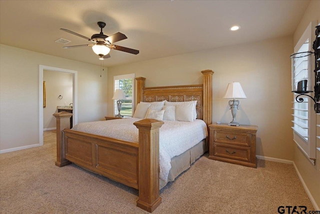 bedroom featuring connected bathroom, ceiling fan, and light colored carpet