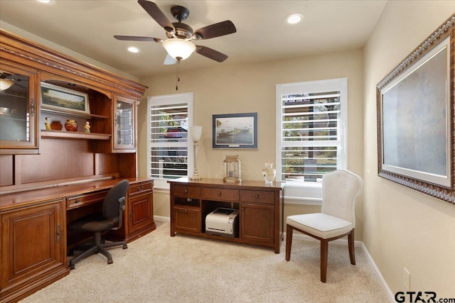 office space featuring light carpet, plenty of natural light, and ceiling fan