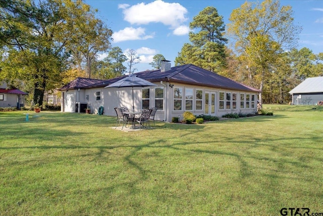 back of house featuring a lawn