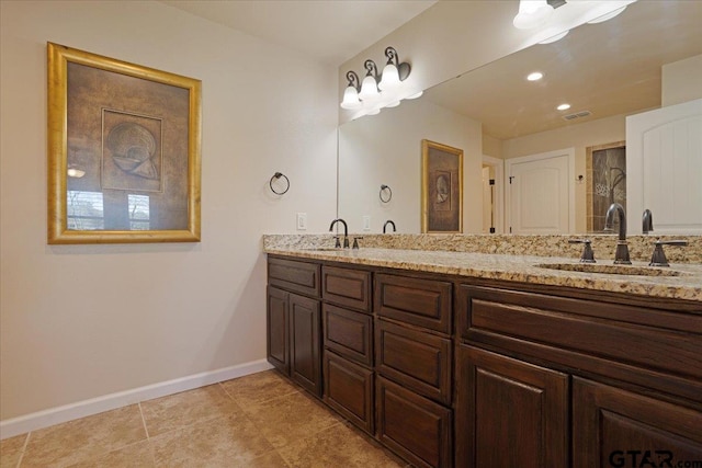 bathroom featuring tile patterned flooring and vanity