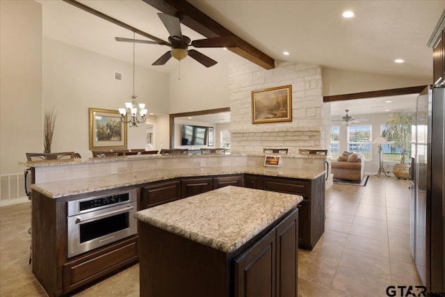 kitchen featuring a center island, decorative light fixtures, and appliances with stainless steel finishes