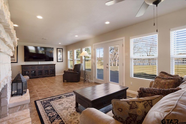 living room featuring ceiling fan, french doors, and light tile patterned floors