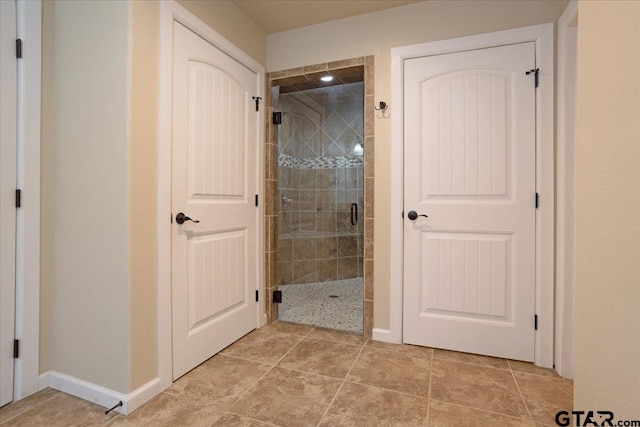 bathroom with tile patterned floors and walk in shower