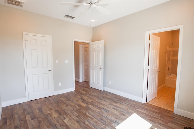 unfurnished bedroom with visible vents, baseboards, and wood finished floors