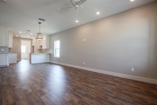 unfurnished living room featuring dark wood finished floors, baseboards, a ceiling fan, and recessed lighting