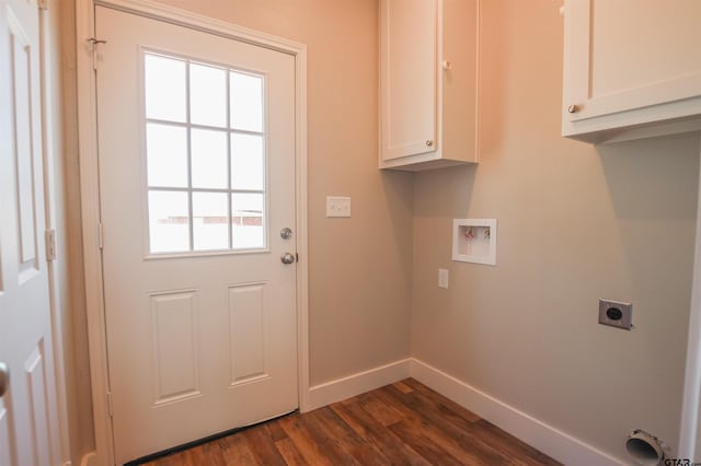 washroom with dark wood finished floors, electric dryer hookup, washer hookup, baseboards, and cabinet space
