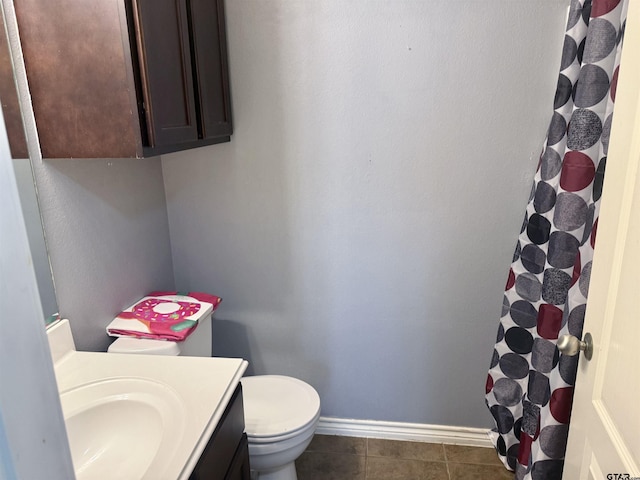 bathroom featuring tile patterned flooring, vanity, and toilet