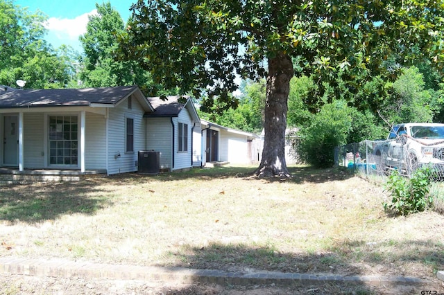 411 N College St, Lindale, TX 75771 - view of yard with central air condition unit, a garage, and a porch