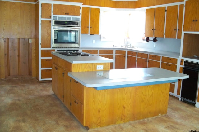 411 N College St, Lindale, TX 75771 - kitchen with stainless steel oven, electric stovetop, a sink, a kitchen island, and light countertops