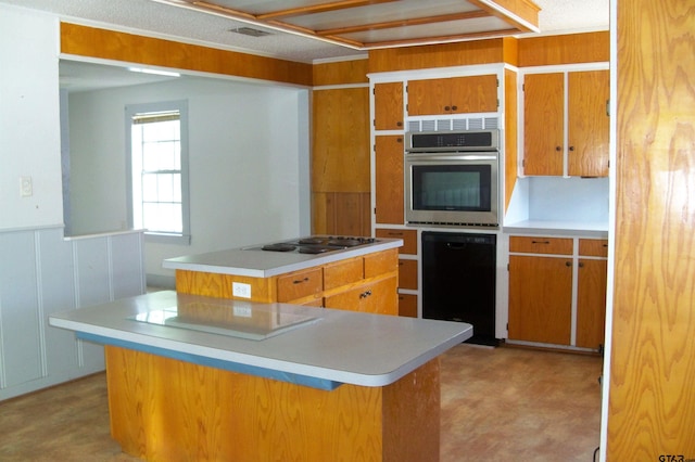 411 N College St, Lindale, TX 75771 - kitchen featuring oven, black dishwasher, a kitchen island, and brown cabinets